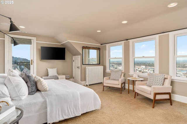 carpeted bedroom with lofted ceiling, radiator, and multiple windows