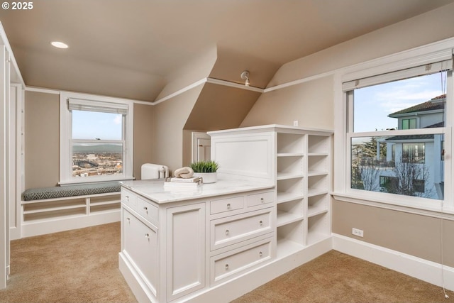 spacious closet featuring light colored carpet and vaulted ceiling