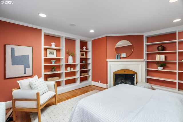 bedroom featuring hardwood / wood-style flooring and crown molding