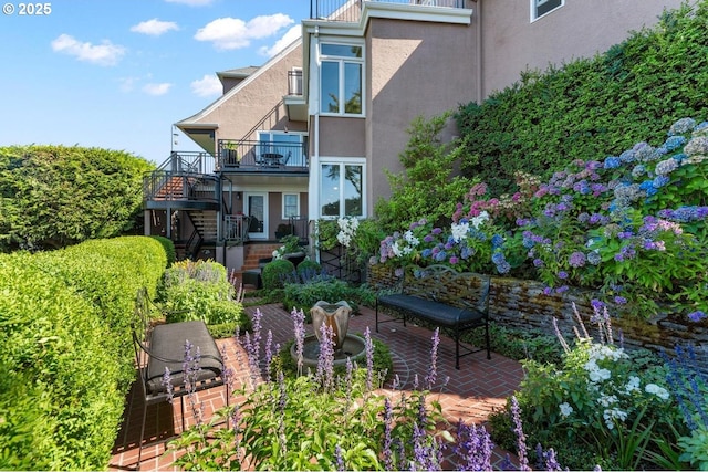 back of house with a balcony and a patio