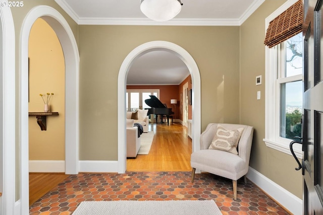 interior space with a healthy amount of sunlight and ornamental molding