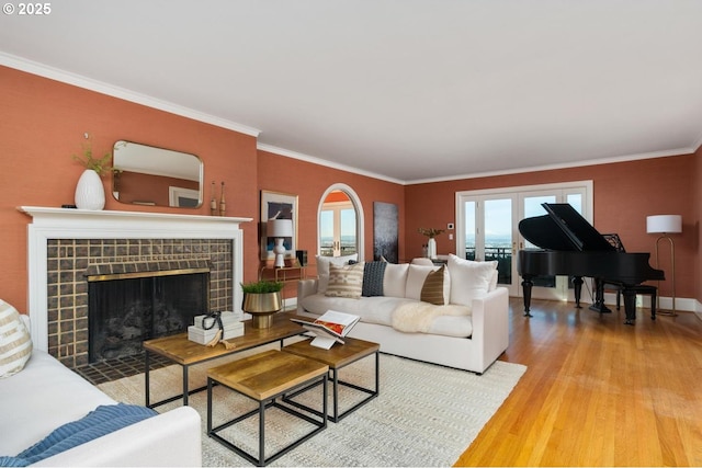 living room featuring a fireplace, hardwood / wood-style floors, and ornamental molding