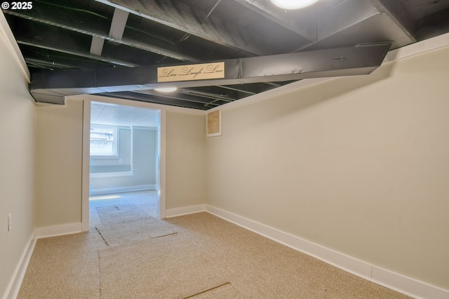 basement with baseboards and carpet flooring