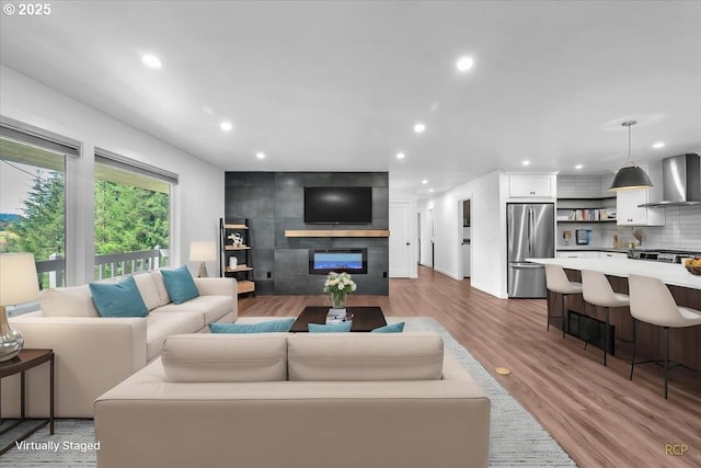 25125 SE Treehill Ln, Damascus, OR 97089 - living room with recessed lighting, wood finished floors, and a large fireplace