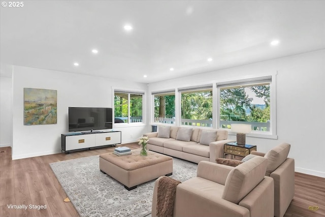 living area with recessed lighting, baseboards, and wood finished floors