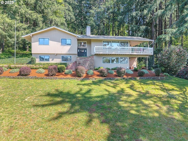 view of front facade with a deck, a chimney, and a front lawn