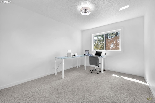 carpeted office featuring a textured ceiling and baseboards