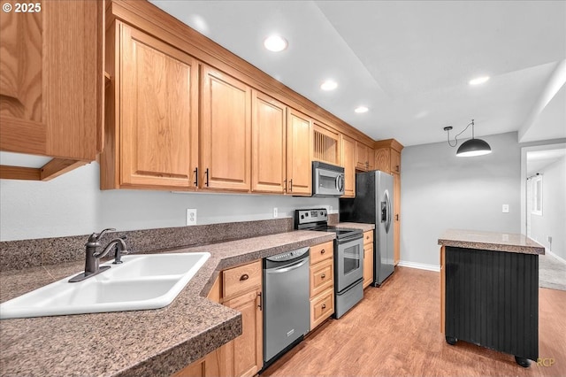 kitchen with a sink, light wood finished floors, tile counters, stainless steel appliances, and recessed lighting