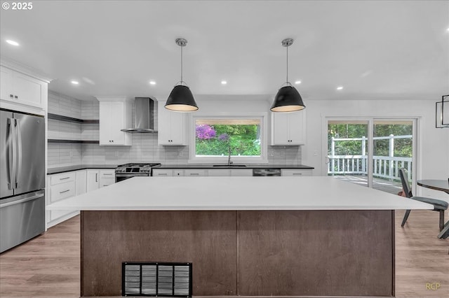 25125 SE Treehill Ln, Damascus, OR 97089 - kitchen with stainless steel appliances, wall chimney exhaust hood, open shelves, decorative backsplash, and recessed lighting