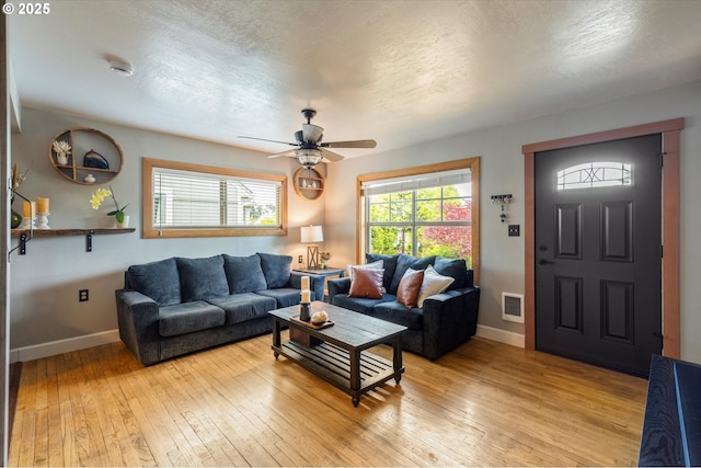 332 26th Ave, Longview, WA 98632 - living area with a ceiling fan, light wood-type flooring, baseboards, and a textured ceiling