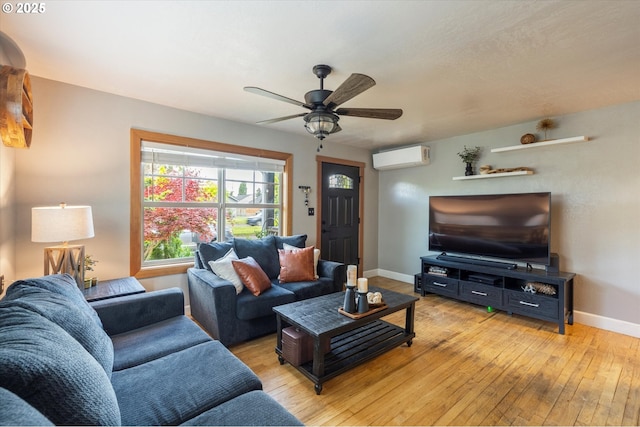 332 26th Ave, Longview, WA 98632 - living area with an AC wall unit, light wood-style flooring, baseboards, and ceiling fan