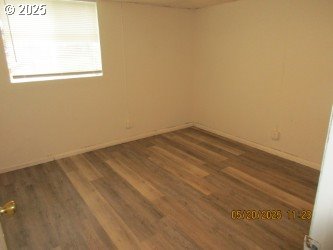 646/648 W Sixth Ave, Sutherlin, OR 97479 - spare room with wood finished floors and baseboards