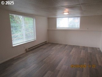 646/648 W Sixth Ave, Sutherlin, OR 97479 - spare room featuring baseboard heating, plenty of natural light, and wood finished floors