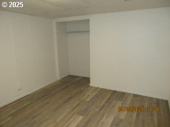 646/648 W Sixth Ave, Sutherlin, OR 97479 - unfurnished bedroom with wood finished floors, a closet, and baseboards