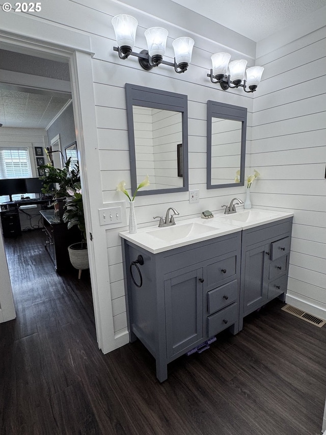 1918 Chestnut St, Baker City, OR 97814 - full bath with wood finished floors, double vanity, wooden walls, and a textured ceiling