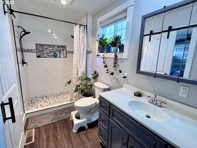 1918 Chestnut St, Baker City, OR 97814 - bathroom featuring wood finished floors, a stall shower, a textured wall, and vanity