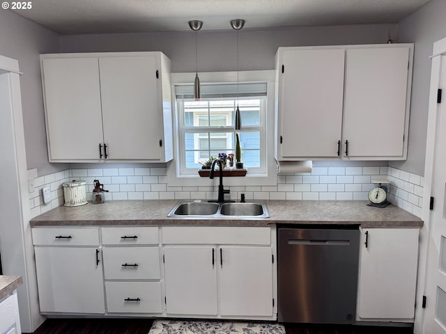 1918 Chestnut St, Baker City, OR 97814 - kitchen with dishwasher, backsplash, white cabinetry, and light countertops