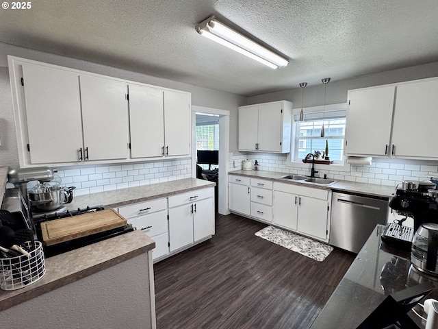 1918 Chestnut St, Baker City, OR 97814 - kitchen with stainless steel dishwasher, backsplash, plenty of natural light, and a textured ceiling