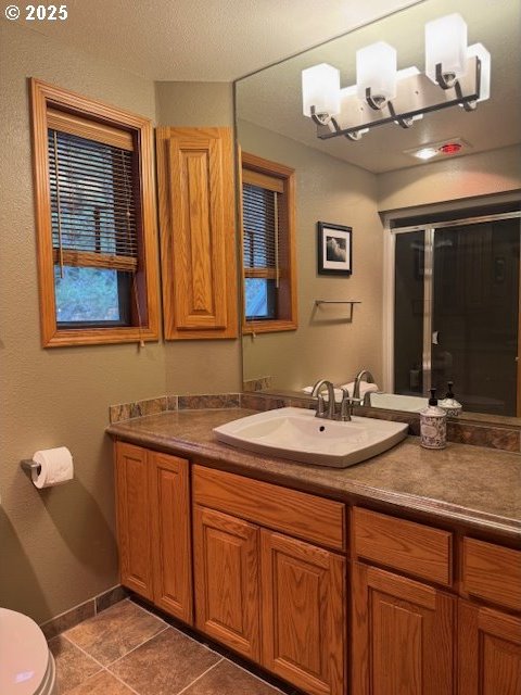 bathroom with tile patterned floors, vanity, and toilet