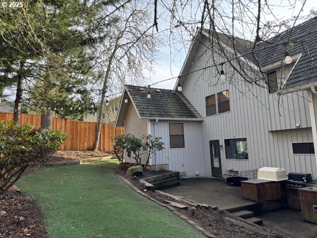 rear view of house with a lawn and a patio area