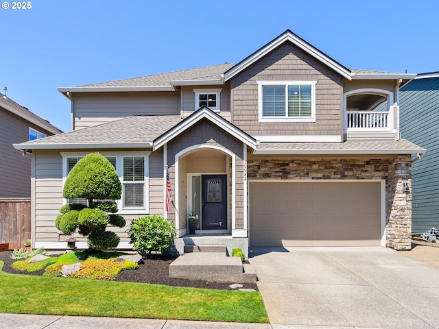 15582 SE Owl Ln, Happy Valley, OR 97015 - view of front of home featuring concrete driveway, a garage, and stone siding