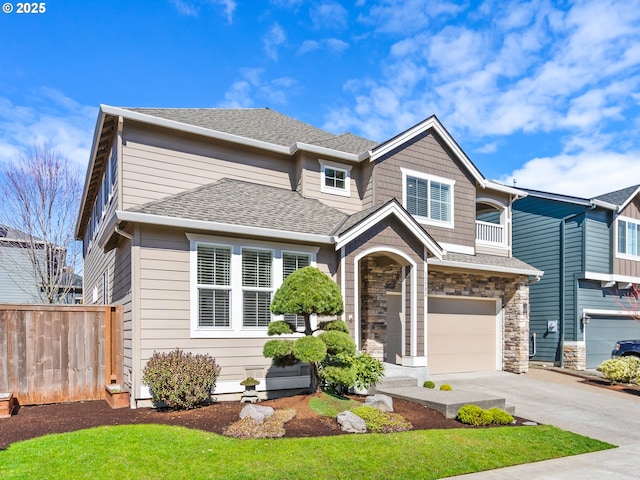 15582 SE Owl Ln, Happy Valley, OR 97015 - view of front facade featuring concrete driveway, an attached garage, stone siding, and a shingled roof