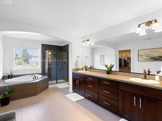 15582 SE Owl Ln, Happy Valley, OR 97015 - full bath featuring double vanity, a shower stall, a bath, tile patterned floors, and a walk in closet