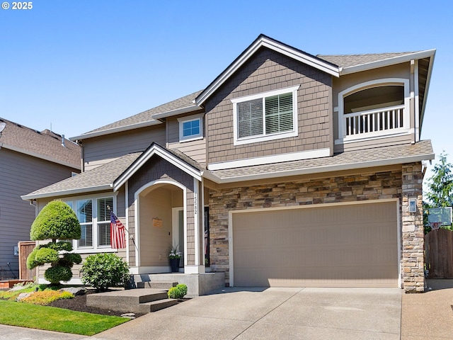 15582 SE Owl Ln, Happy Valley, OR 97015 - view of front of house featuring an attached garage, driveway, stone siding, and roof with shingles