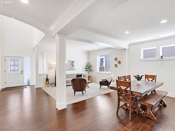 15582 SE Owl Ln, Happy Valley, OR 97015 - dining room with decorative columns, ornamental molding, dark wood-type flooring, recessed lighting, and healthy amount of natural light