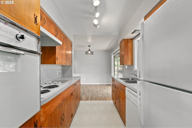 2431 W Crestview Ave, Roseburg, OR 97471 - kitchen featuring white appliances, brown cabinets, light countertops, and under cabinet range hood