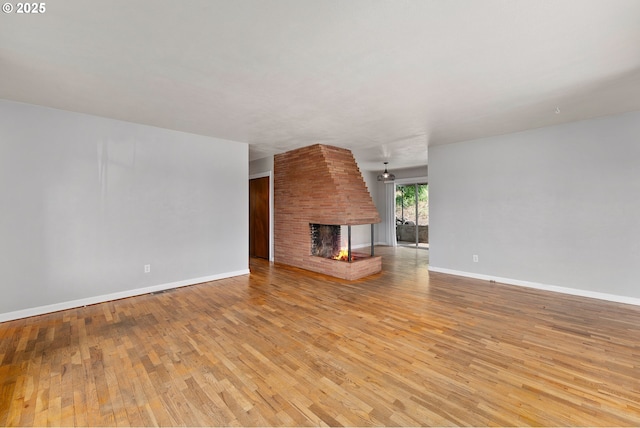 2431 W Crestview Ave, Roseburg, OR 97471 - unfurnished living room featuring a fireplace and light wood-style flooring
