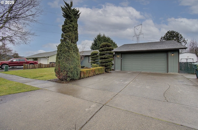 view of front of property featuring a front lawn and a garage