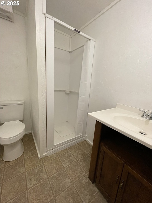 154 Decoy Ln, Myrtle Creek, OR 97457 - bathroom featuring vanity, a stall shower, toilet, and baseboards