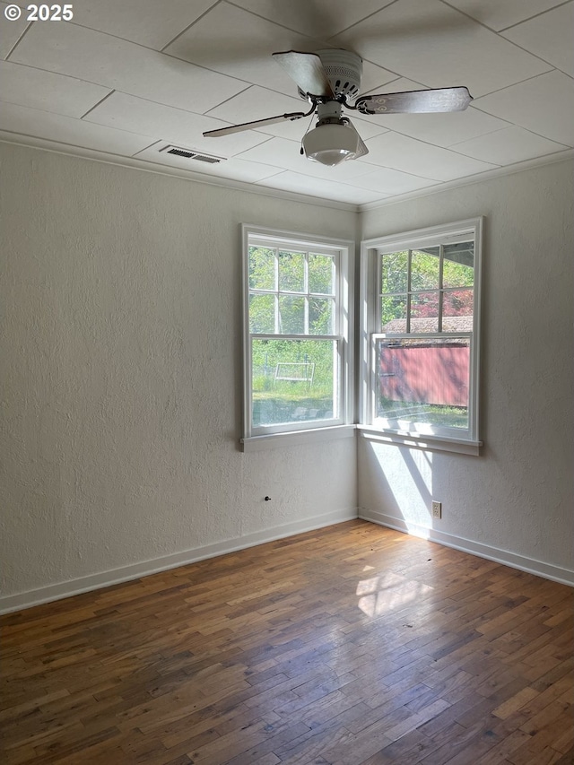 154 Decoy Ln, Myrtle Creek, OR 97457 - empty room with a textured wall, healthy amount of natural light, hardwood / wood-style floors, a ceiling fan, and baseboards