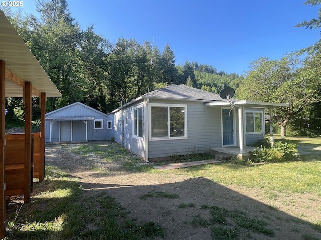 154 Decoy Ln, Myrtle Creek, OR 97457 - back of house with an outbuilding, roof with shingles, and a lawn