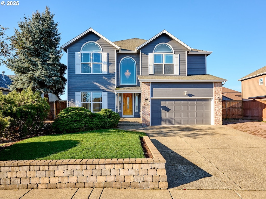 view of front of house with a front yard and a garage