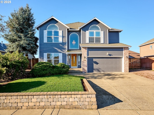 view of front of house with a front yard and a garage