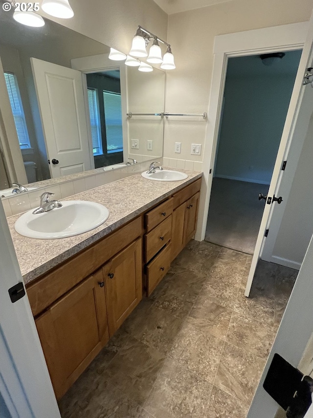 6721 N Yale St, Portland, OR 97203 - bathroom featuring double vanity and stone finish floors