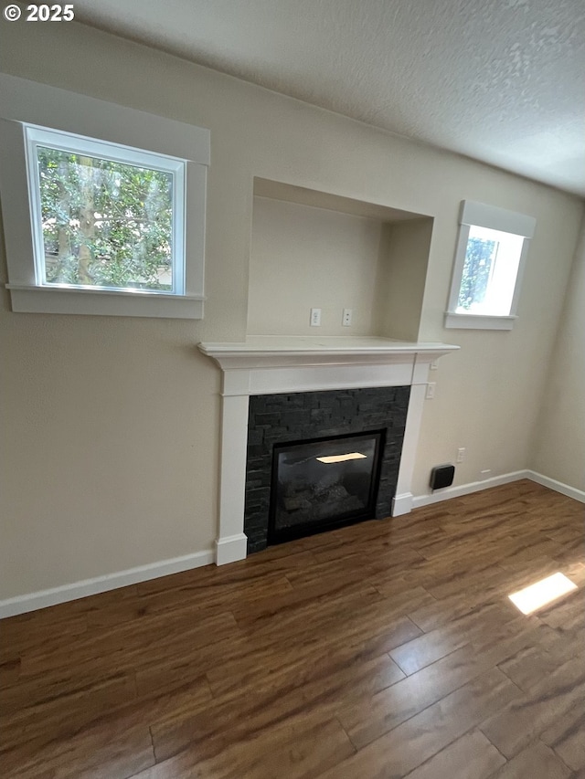 6721 N Yale St, Portland, OR 97203 - detailed view of a glass covered fireplace, wood finished floors, and a textured ceiling