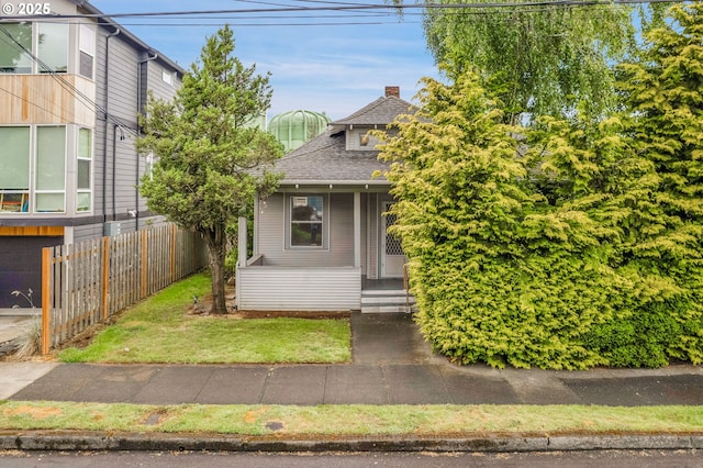 4455 NE 22nd Ave, Portland, OR 97211 - view of front of property featuring covered porch, roof with shingles, and a chimney