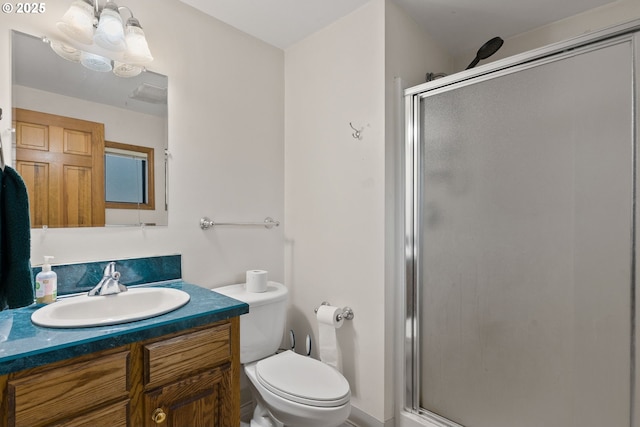 full bathroom featuring a shower stall, toilet, and vanity