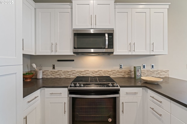 7314 NE 66th St, Vancouver, WA 98662 - kitchen with stainless steel appliances, dark countertops, and white cabinetry