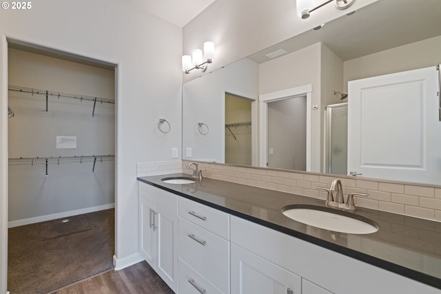 7314 NE 66th St, Vancouver, WA 98662 - full bathroom with wood finished floors, tasteful backsplash, a stall shower, and a spacious closet