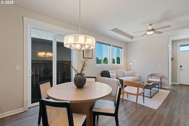 7314 NE 66th St, Vancouver, WA 98662 - dining room featuring dark wood-style flooring, baseboards, a raised ceiling, ceiling fan, and a chandelier