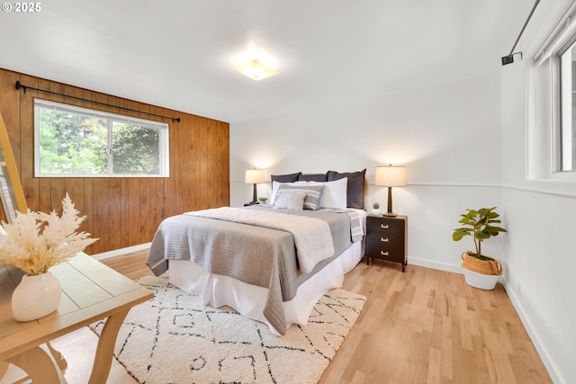 2801 Kincaid St, Eugene, OR 97405 - bedroom with baseboards, wooden walls, and light wood-style floors