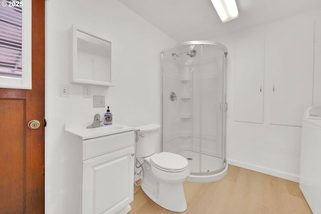 2801 Kincaid St, Eugene, OR 97405 - bathroom featuring a shower stall, toilet, wood finished floors, and washer / clothes dryer