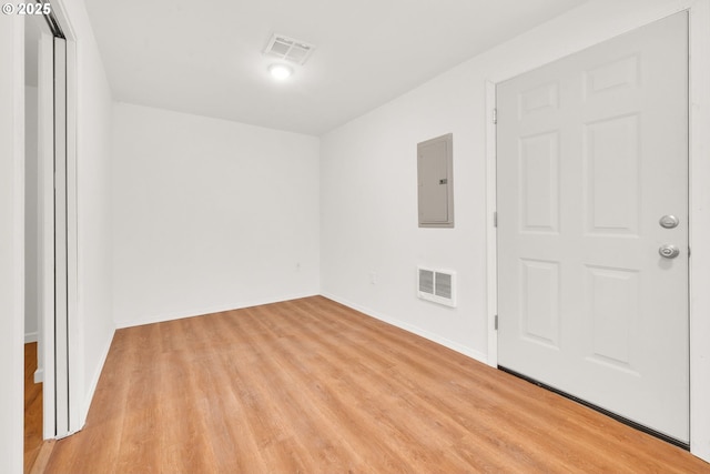 2801 Kincaid St, Eugene, OR 97405 - empty room with electric panel, light wood-type flooring, and baseboards