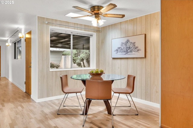 2801 Kincaid St, Eugene, OR 97405 - dining room with baseboards, light wood-type flooring, wooden walls, and ceiling fan