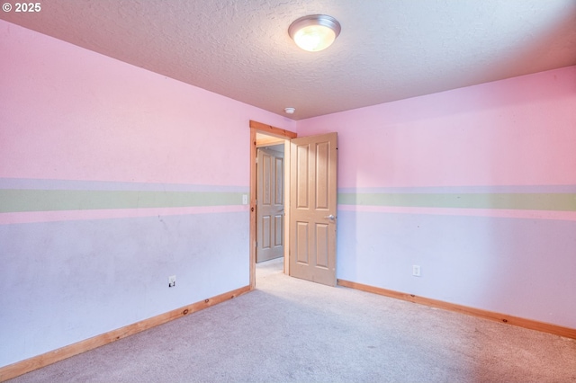 carpeted spare room with a textured ceiling