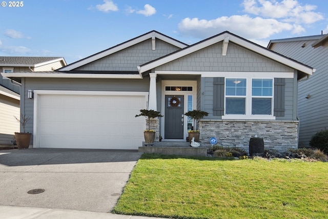 view of front of house with stone siding, an attached garage, driveway, and a front lawn